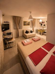 a bedroom with a large bed and a living room at AMD Infinity Suites in Split