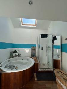 a bathroom with a large tub and a shower at Loft au cœur du Mans in Le Mans