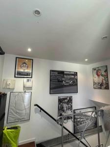 a room with pictures on the wall and a treadmill at Loft au cœur du Mans in Le Mans