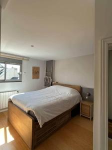 a bedroom with a large bed and a window at Loft au cœur du Mans in Le Mans