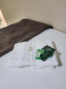 a white towel sitting on top of a bed at Pousada King in Vitória da Conquista +51 photos