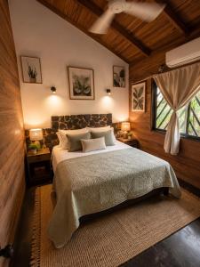 a bedroom with a large bed and a window at Anam Apartments in Santa Teresa Beach
