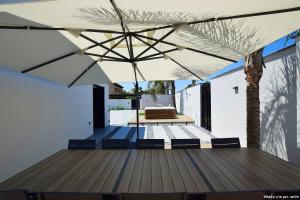 an outdoor deck with a table and an umbrella at Ville delle luci in Tefahot