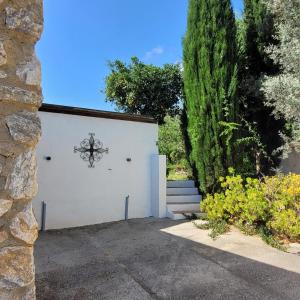 a white garage with a gate and a tree at Cortijo La Joya in Lanjarón