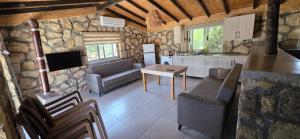 a kitchen and living room with a couch and a table at Borak's Stone Village in Rizokarpaso