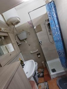 a bathroom with a shower and a toilet and a sink at la casetta di ciacione piazza del plebiscito in Naples +58 photos
