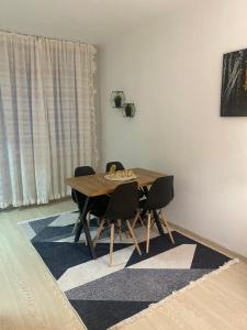 a dining room with a table and chairs on a rug at Nestorovski House in Bitola +10 photos