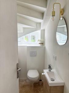 a bathroom with a white toilet and a sink at Escapade Lotoise in Cahors