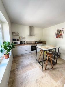 a kitchen with a table and chairs in it at Escapade Lotoise in Cahors +9 photos