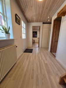 an empty hallway with wood floors and a ceiling at Tranum B&B in Brovst