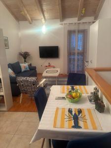 a living room with a table and a couch at Takoma Hvar in Hvar