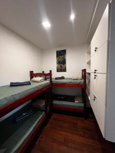 a room with two bunk beds and a closet at Sunset Hostel in Brasília