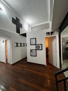a room with a white wall with pictures on it at Sunset Hostel in Brasília