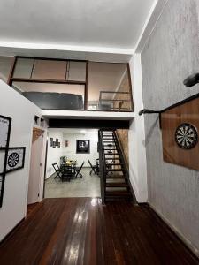 a room with a staircase and a living room with a table at Sunset Hostel in Brasília +5 photos