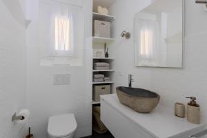 a white bathroom with a sink and a toilet at Studio lumineux avec jardin privé et parking in La Turbie