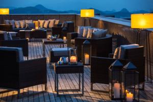 a rooftop patio with couches and tables and candles at Renaissance Guiyang Hotel in Guiyang
