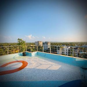 a balcony of a building with a view of a city at Rooftopwaves penthouse in Daman