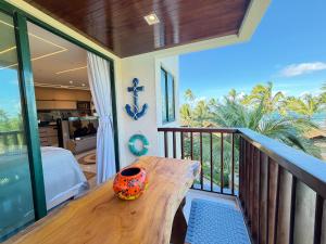 a balcony with a table and a view of the ocean at Marulhos resort Muro Alto flats Premium frente ao mar in Porto De Galinhas +131 photos