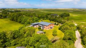 an aerial view of a large house on a field at Ferienwohnung Lille Hus 3 St Peter-Ording in Böhl