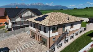 a house with solar panels on the roof at Apartmány Virbo in Vrbov