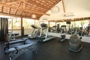 a gym with treadmills and elliptical machines at Hotel Manati in Barra Grande