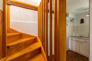 a staircase in a room with a sink and a kitchen at Lütt Kate Hemmelmark in Louisenberg +43 photos