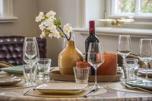 a table with a bottle of wine and glasses at Die Perle von Wenningstedt in Braderup +47 photos