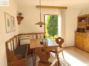 a dining room with a wooden table and a window at Ferienhaus Kleinod in Bad Aussee