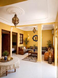 a living room with yellow walls and a table at Marrakech Family in Marrakesh