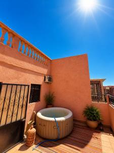 a hot tub sitting on a deck on a balcony at Marrakech Family in Marrakesh
