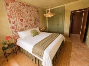 a bedroom with a large bed in a room at Wellness Farm Villa - Monte Valeo in Coín