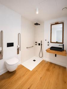 a bathroom with a toilet and a sink at Do Bico Rooms in Camariñas +30 photos