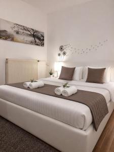 a large white bed with two pillows on it at Boróka Panzió in Parád