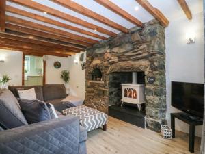a living room with a stone fireplace at Old Chapel House in Llanfairfechan