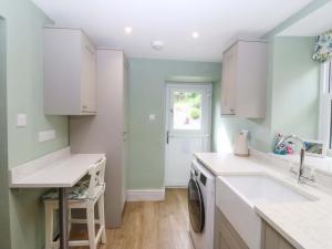 a kitchen with a sink and a dishwasher at Old Chapel House in Llanfairfechan +25 photos