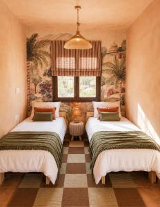 two beds sitting in a room with a window at Wellness Farm Villa - Monte Valeo in Coín