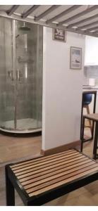 a room with a shower with a bench and a table at Studio Cosy Ax-les-Thermes Centre in Ax-les-Thermes