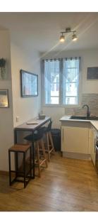 a kitchen with a table and chairs and a sink at Studio Cosy Ax-les-Thermes Centre in Ax-les-Thermes