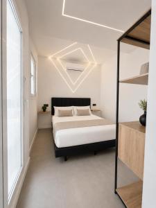 a bedroom with a bed and a large window at ApartamentosCRP in Almería