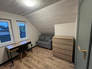 a room with a desk and a couch and a bed at Perła prosto z Borów in Cekcyn +4 photos