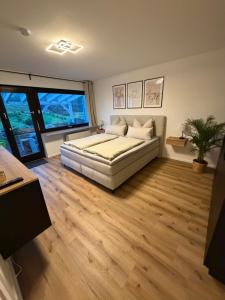 a large bedroom with a bed and wooden floors at Ferienwohnung Bächle in Bad Peterstal +31 photos