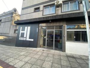 a building with its doors open on a street at HL Hotel in Pelotas