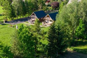 an overhead view of a log home with a blue roof at Domki Skitnica in Mirsk