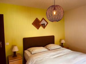 a bedroom with a bed and two lamps and a light at Chez Sophie in Spa