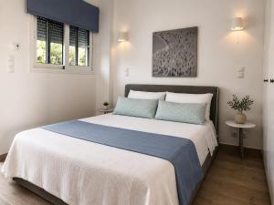a bedroom with a large bed in a room at Galinio Boutique Apartments in Skafidia +70 photos