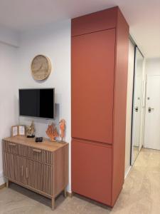 a large red cabinet in a room with a tv at French Riviera Chic Cocoon - pool, beach, parking in Antibes
