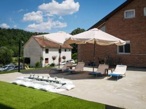 a patio with chairs and an umbrella and a fountain at Vikendica Garaski kutak sprat in Arandelovac +14 photos