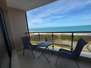 a balcony with a table and chairs and a view of the ocean at Infinity Sea View Studio in Pomorie