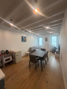 a living room with a table and chairs in it at Vittoria Tre Piazze Apartments in Brescia