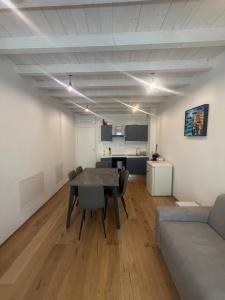 a living room with a table and a couch at Vittoria Tre Piazze Apartments in Brescia